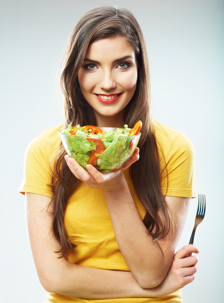 Young woman eating a salad