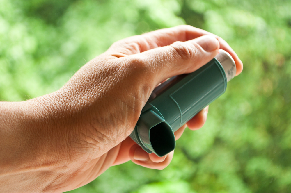Asthma inhaler outdoors around allergens