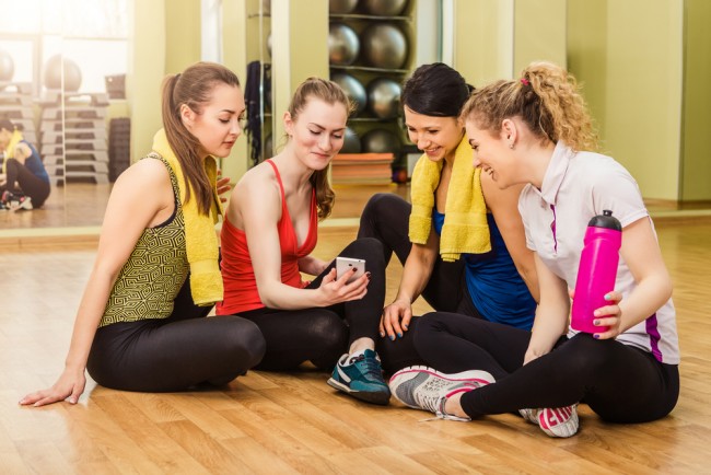 A group of women looking at something exciting in a Smartphone.