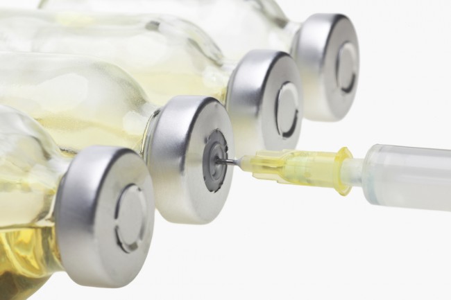 Glass Vials with collagen syringe on a white background