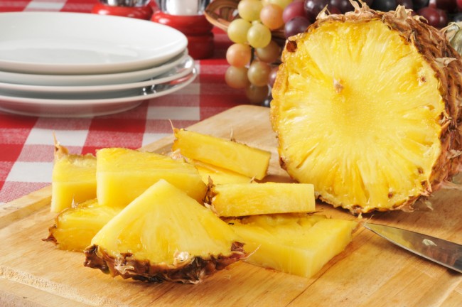 Sliced pineapples on a wooden board