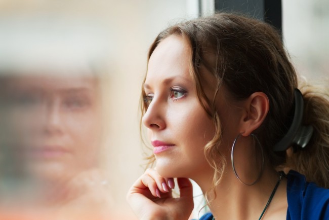 Woman looking out of the window and thinking.