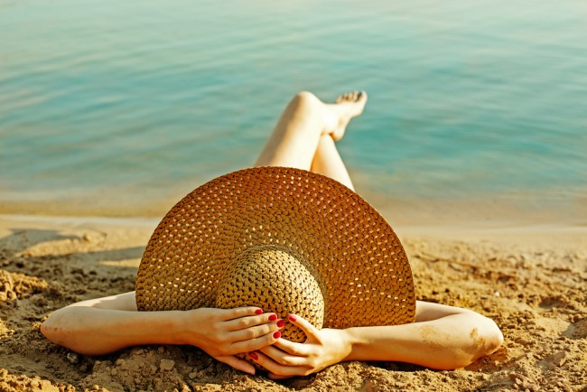 Woman wearing a hat sunbathing