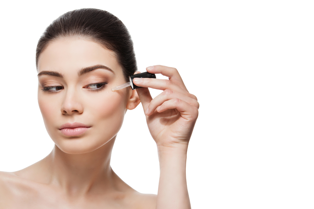 Woman applying serum