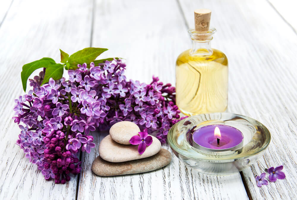 Lavender essential oil on white table