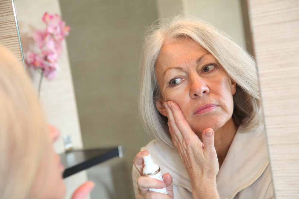 Mature woman looking in the mirror 