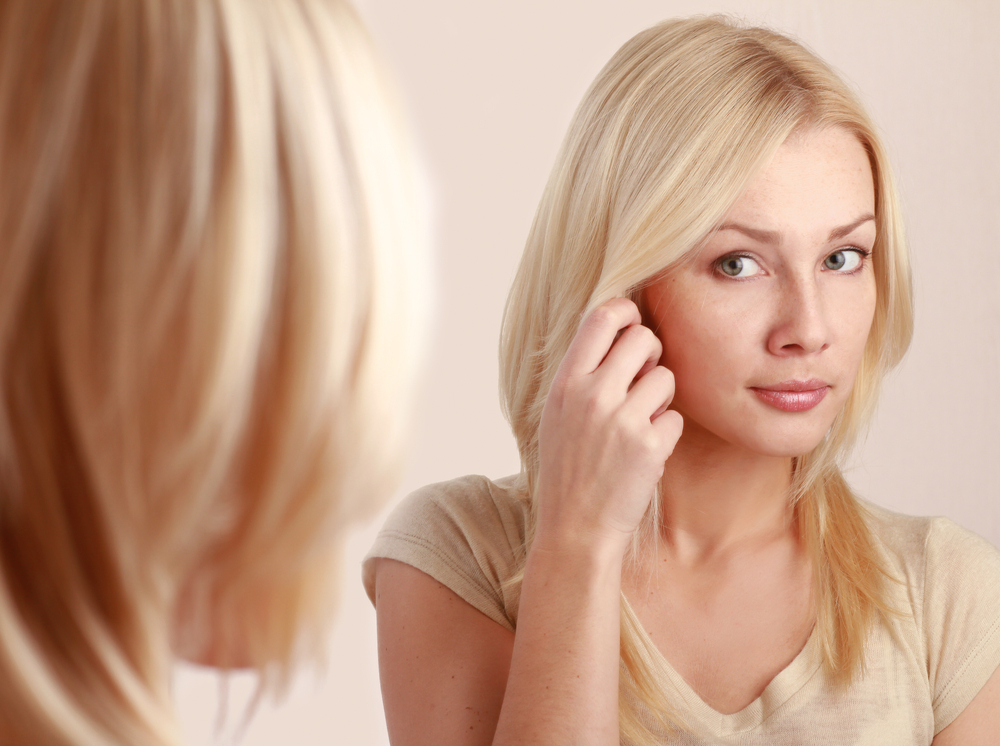 woman looking at skin