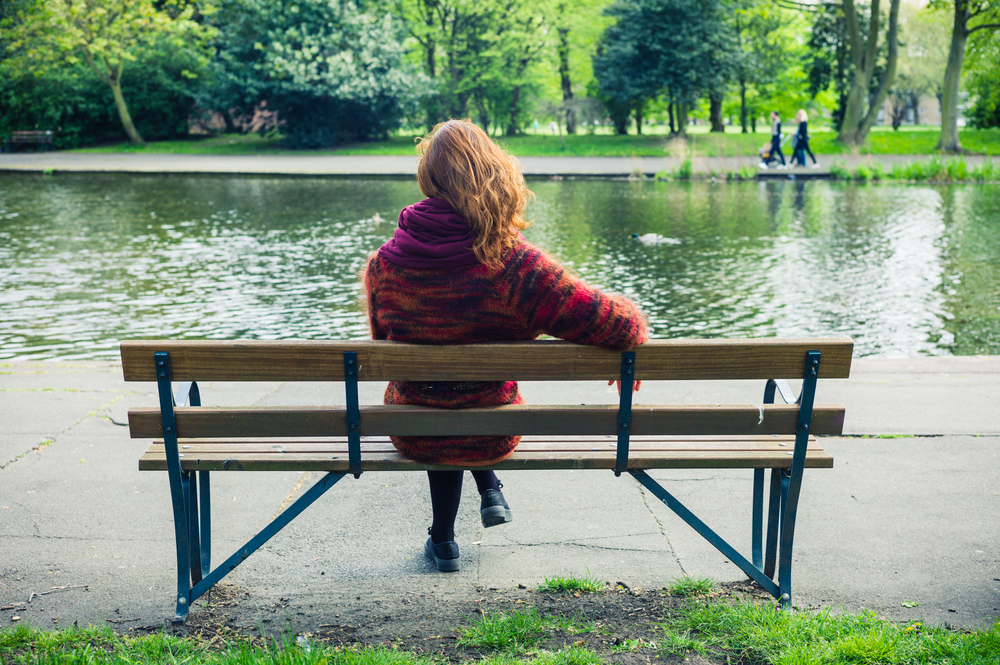 Woman sitting on park bench