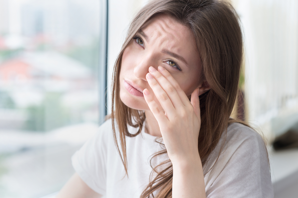 Woman rubbing eye