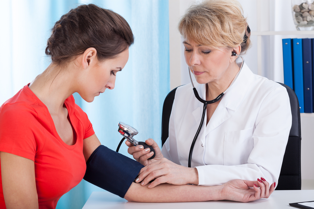 Woman taking her blood pressure