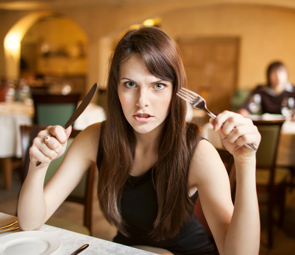 hungry woman with empty plate