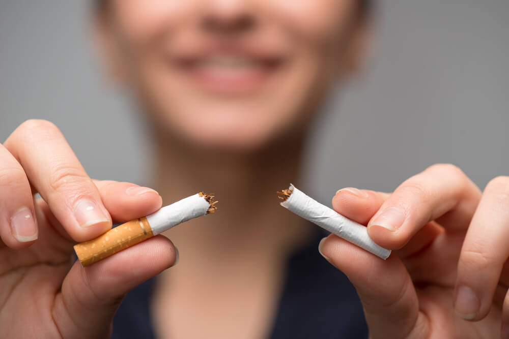 woman breaking cigarette