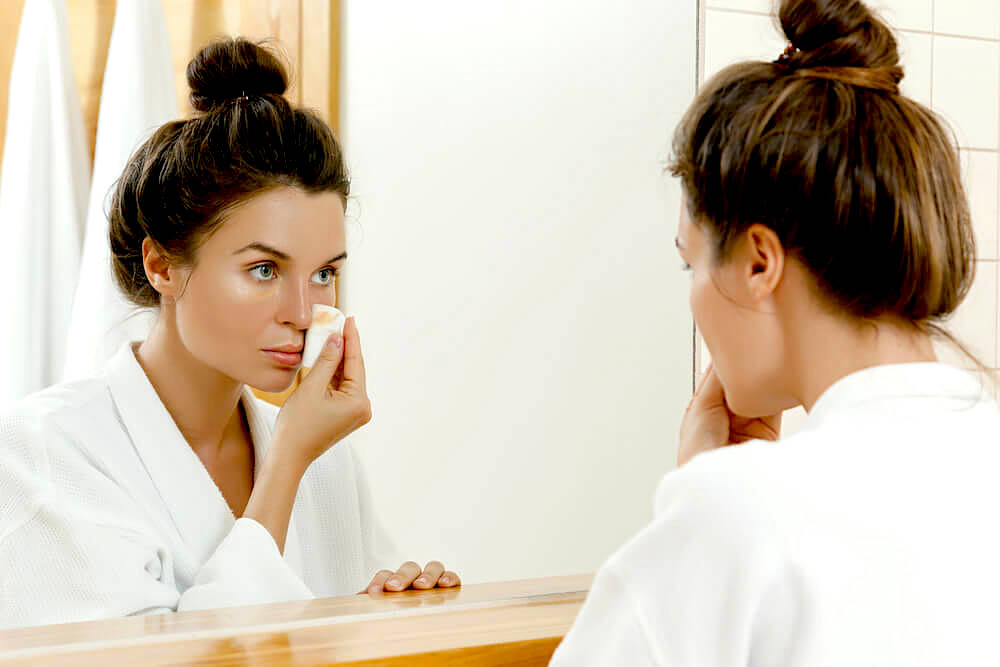 woman removing makeup before bed