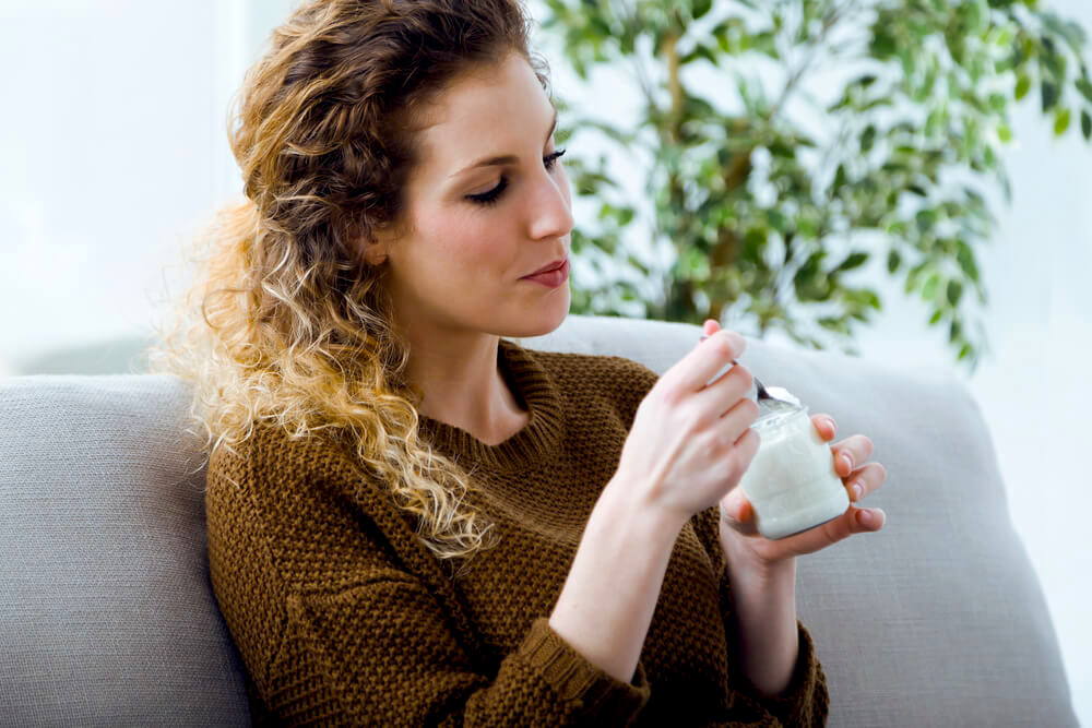 woman eating yogurt