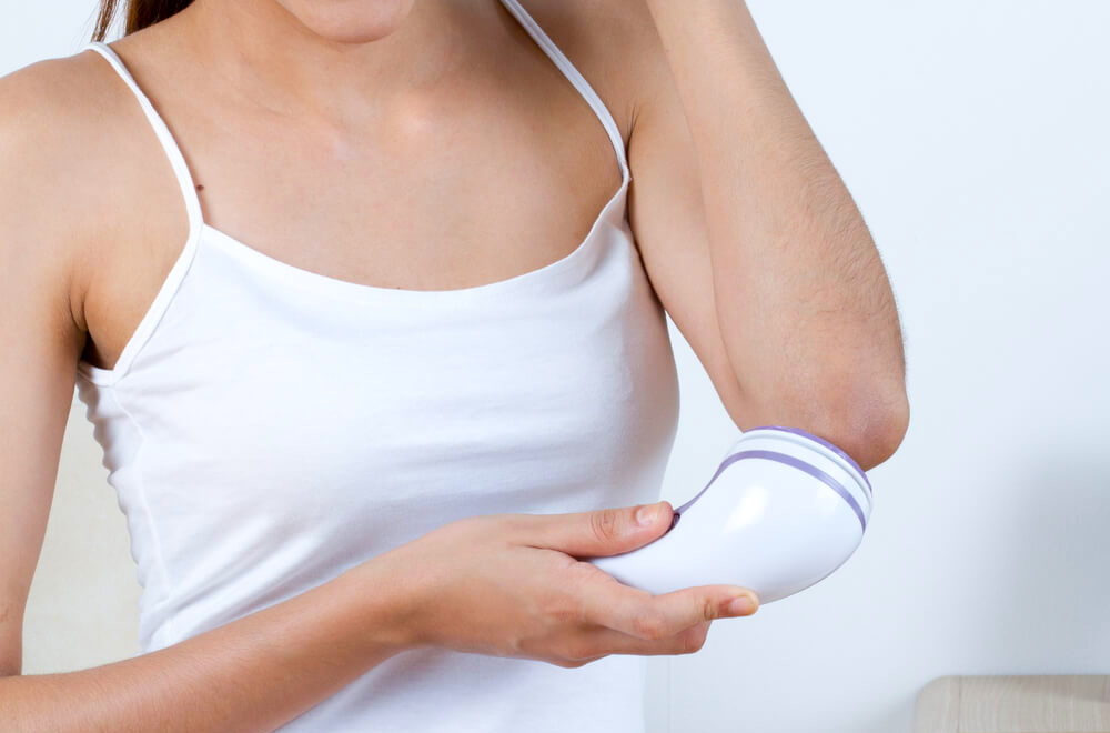 woman exfoliating elbow