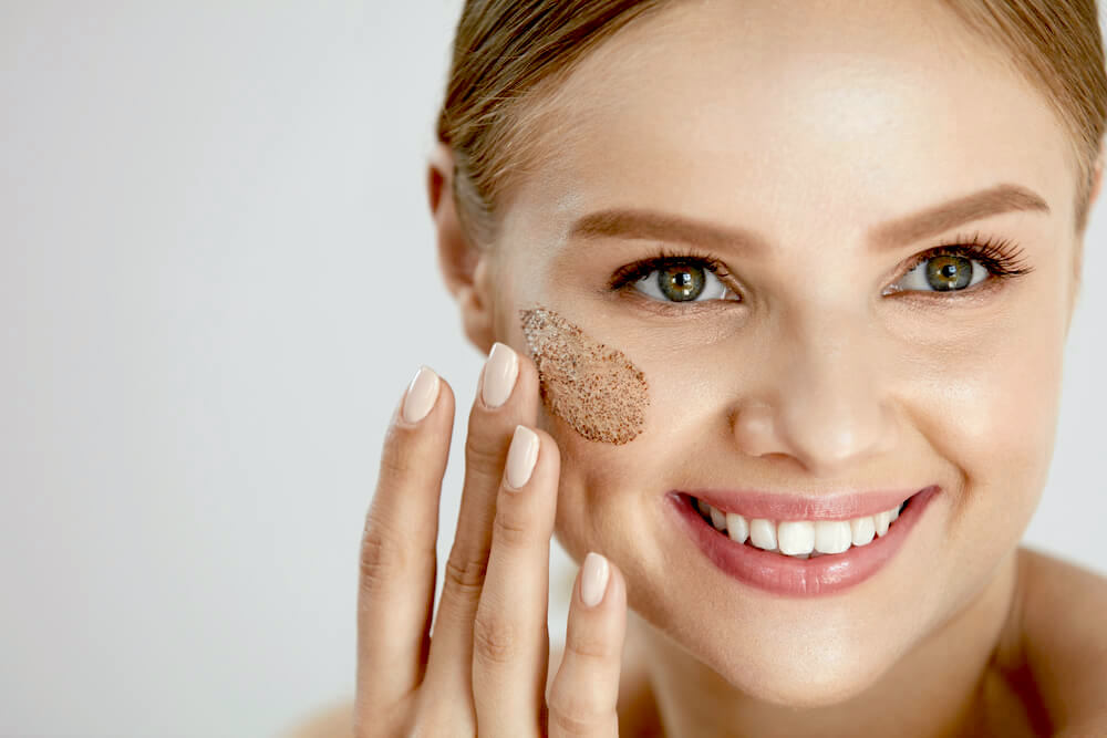 woman using face scrub