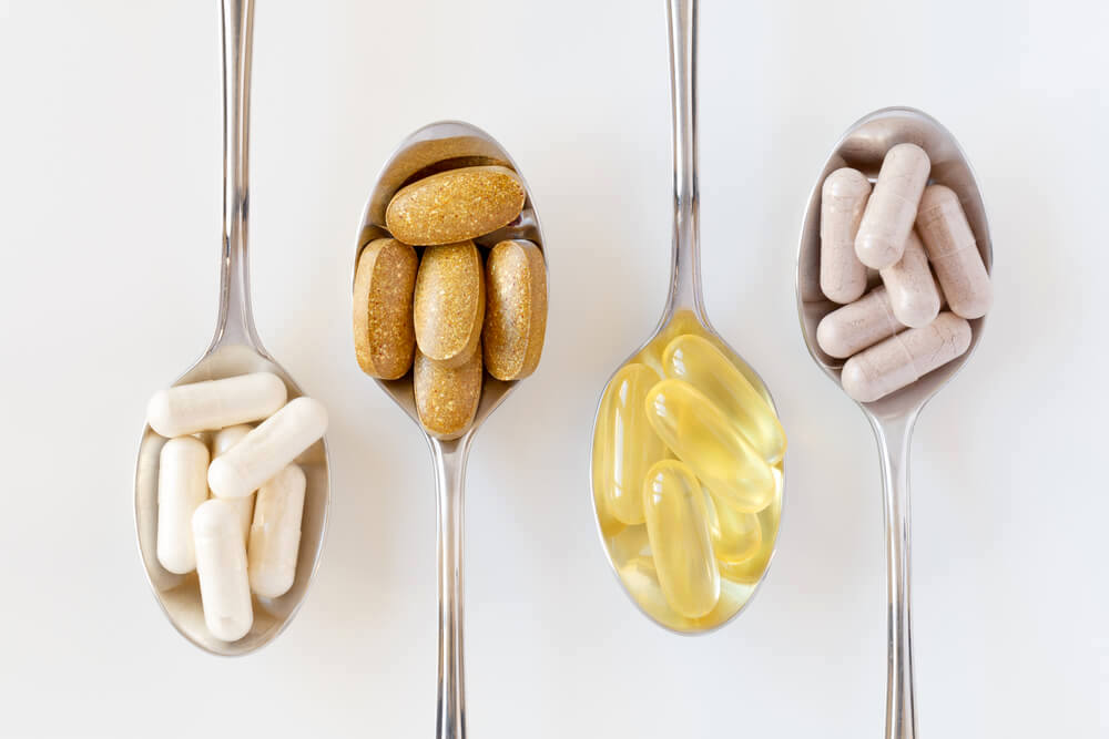 Assorted vitamin supplements on spoons