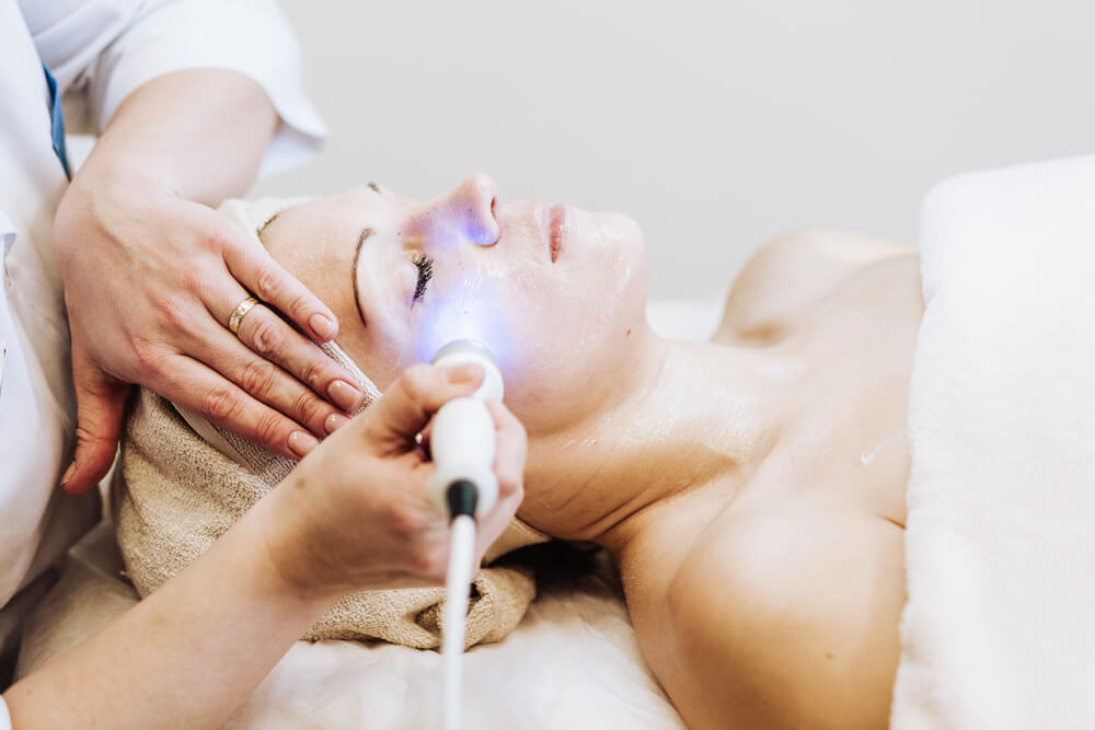 Woman undergoing laser skin treatment 