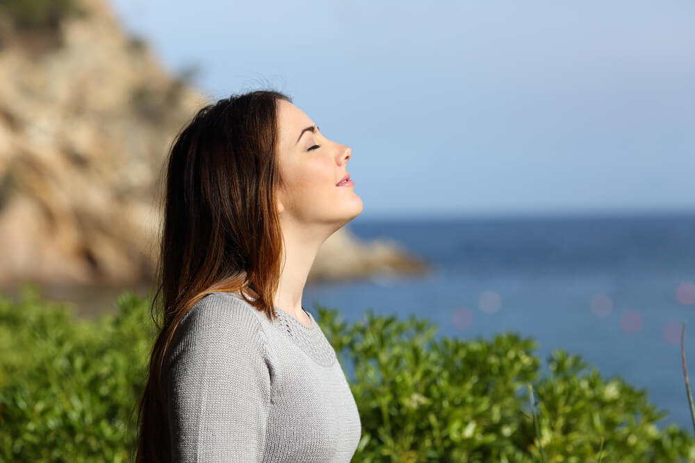 Happy relaxed woman enjoying the outdoor sun